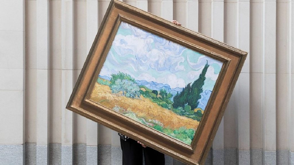 someone holding a painting up of a tree and countryside landscape