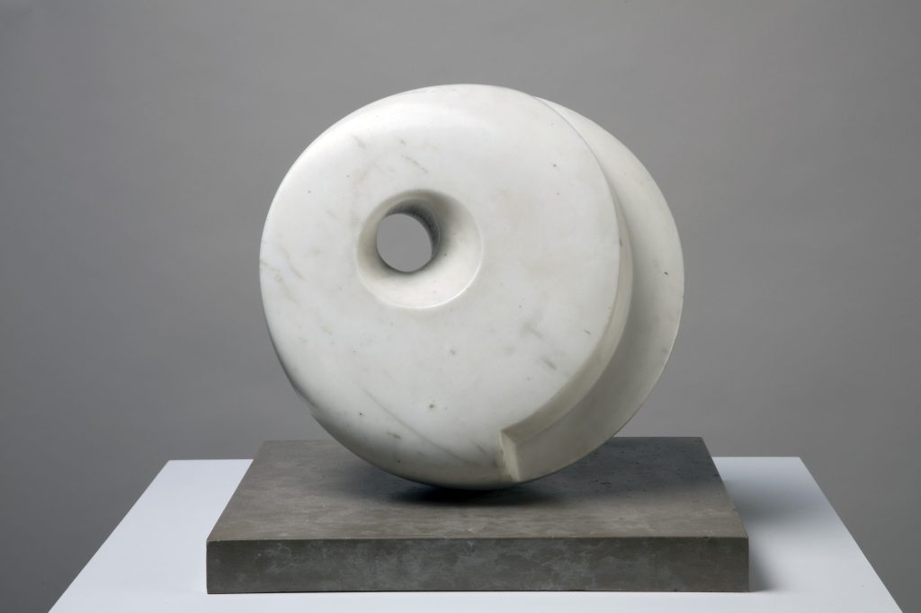 a sculpture which is a round piece with a hole through it