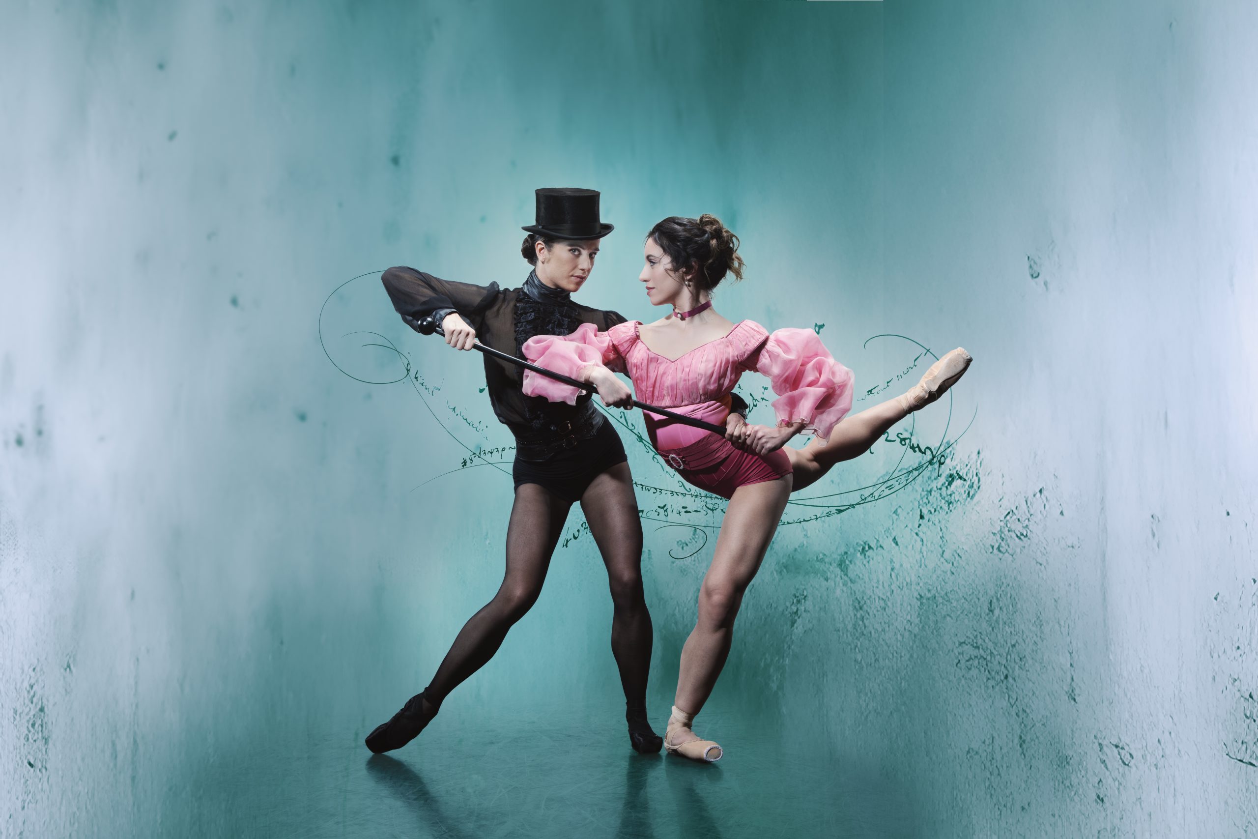two dancers posing, one with a top hat and cane
