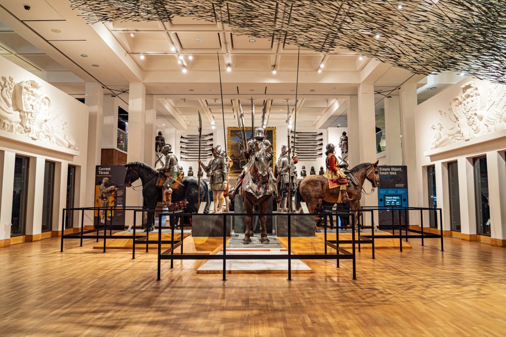 a display in a museum of soldiers on horseback in a variety of armour and weaponry