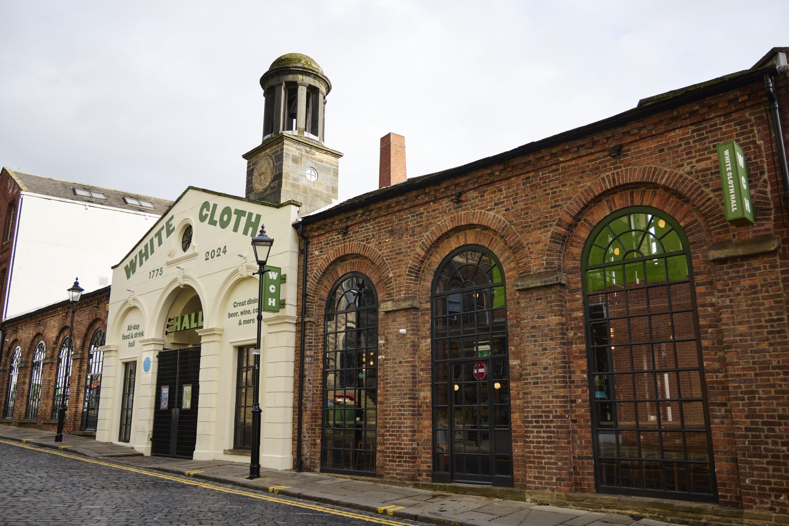 a brick building on a cobbled street