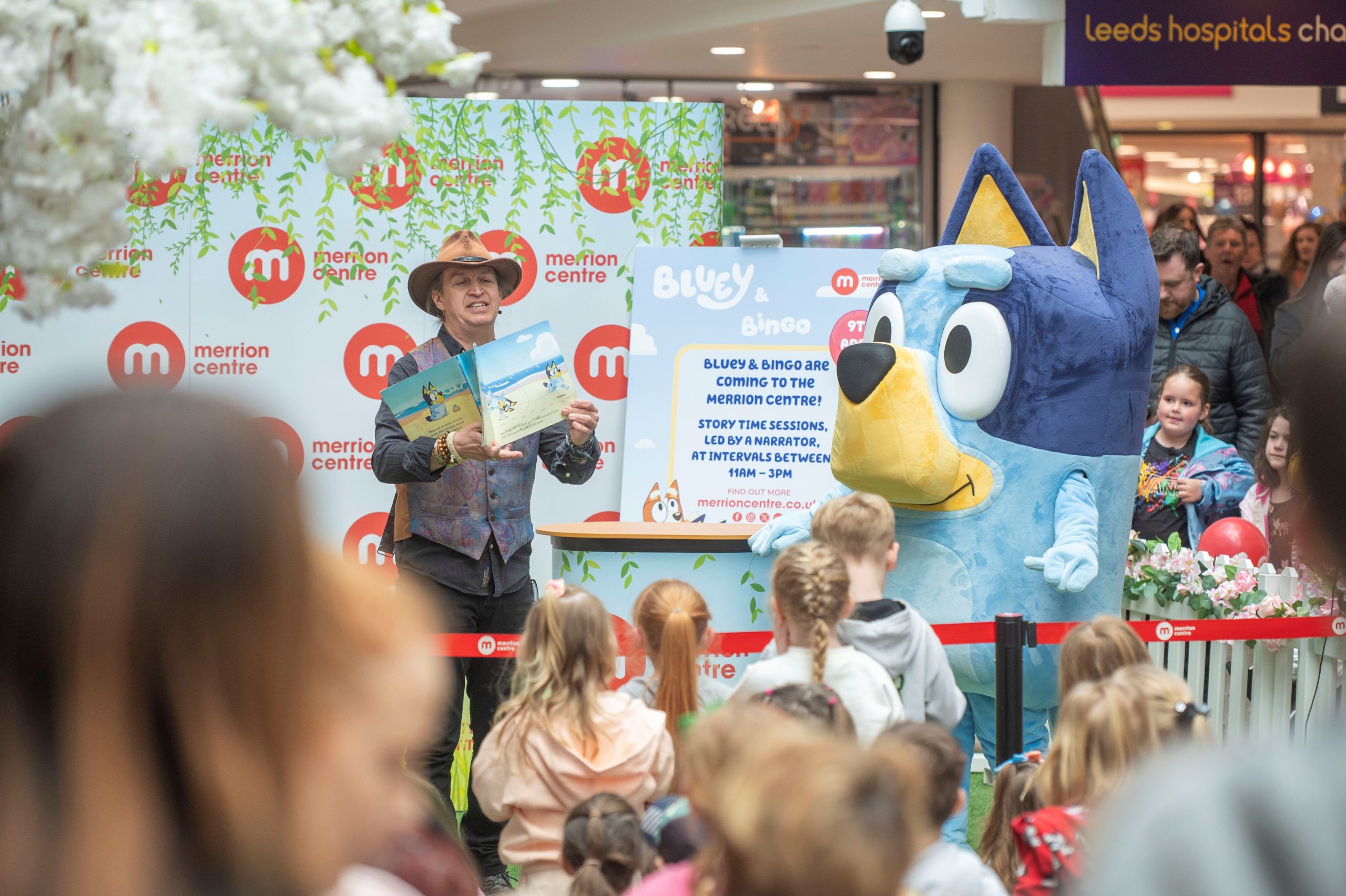 a crowd of children watching Bluey the dog perform