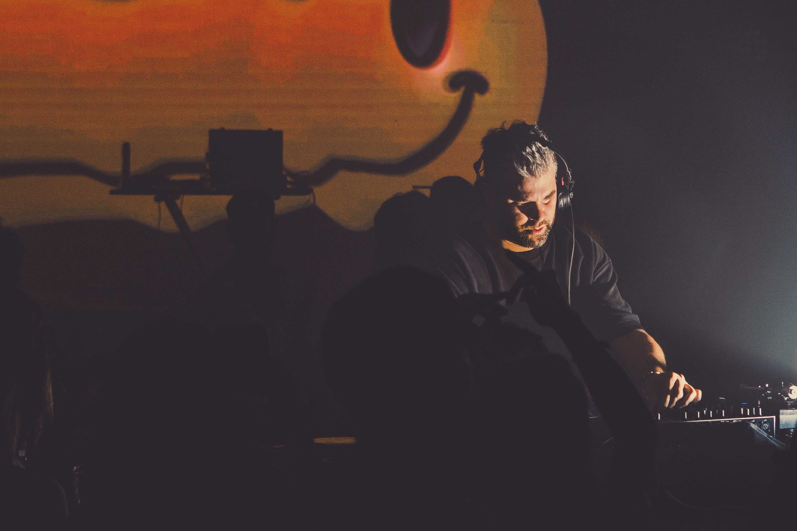 a dj at a dimly lit venue