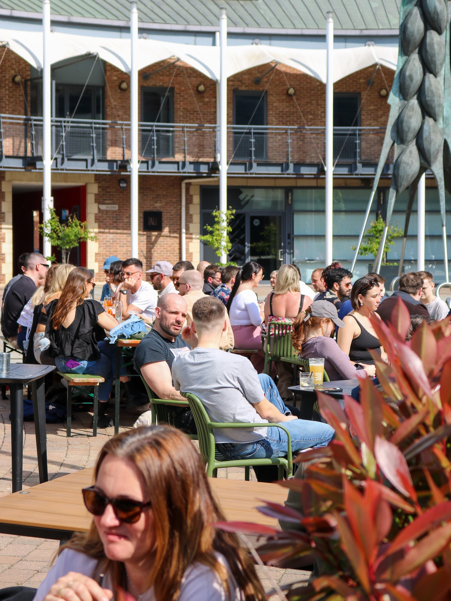 Image of Brewery Wharf with crowds of people enjoying the sunshine on deck chairs