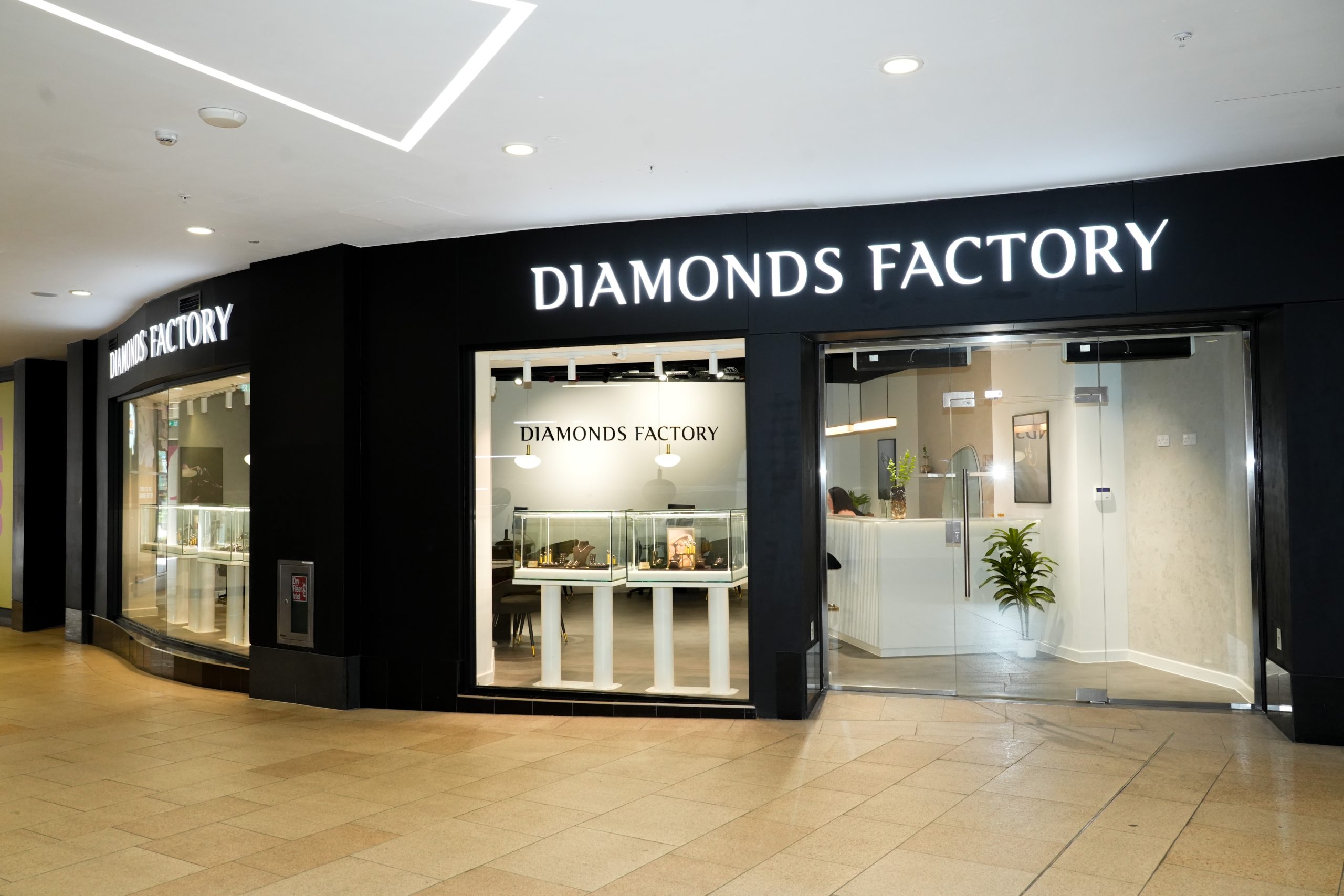 the exterior of a shop inside a shopping centre, with large windows and a sign saying diamond factory