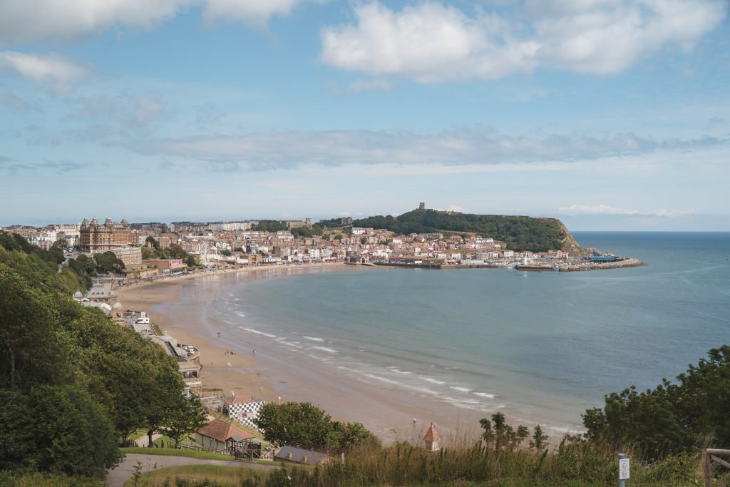 Photograph looking out over Scarborough Bay from above.