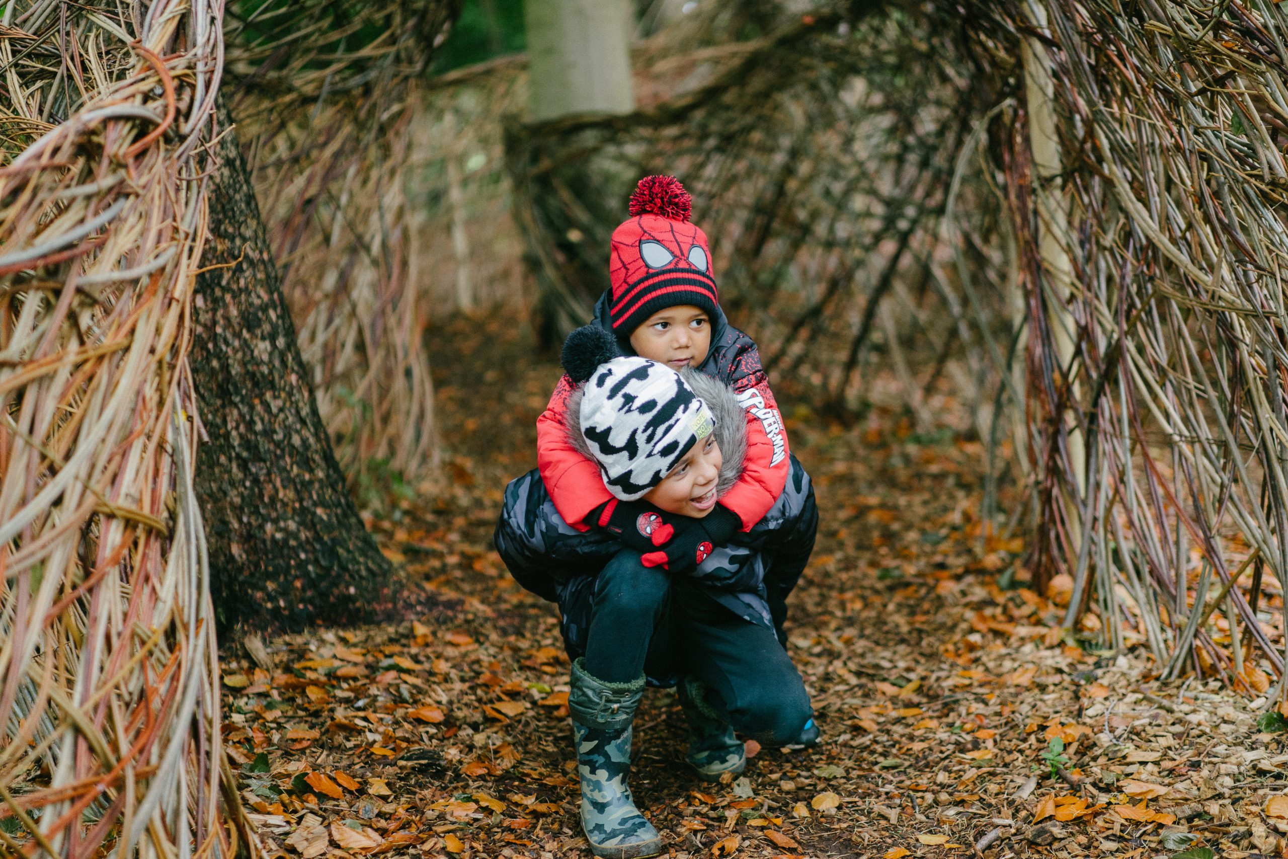 two children playing in woodland