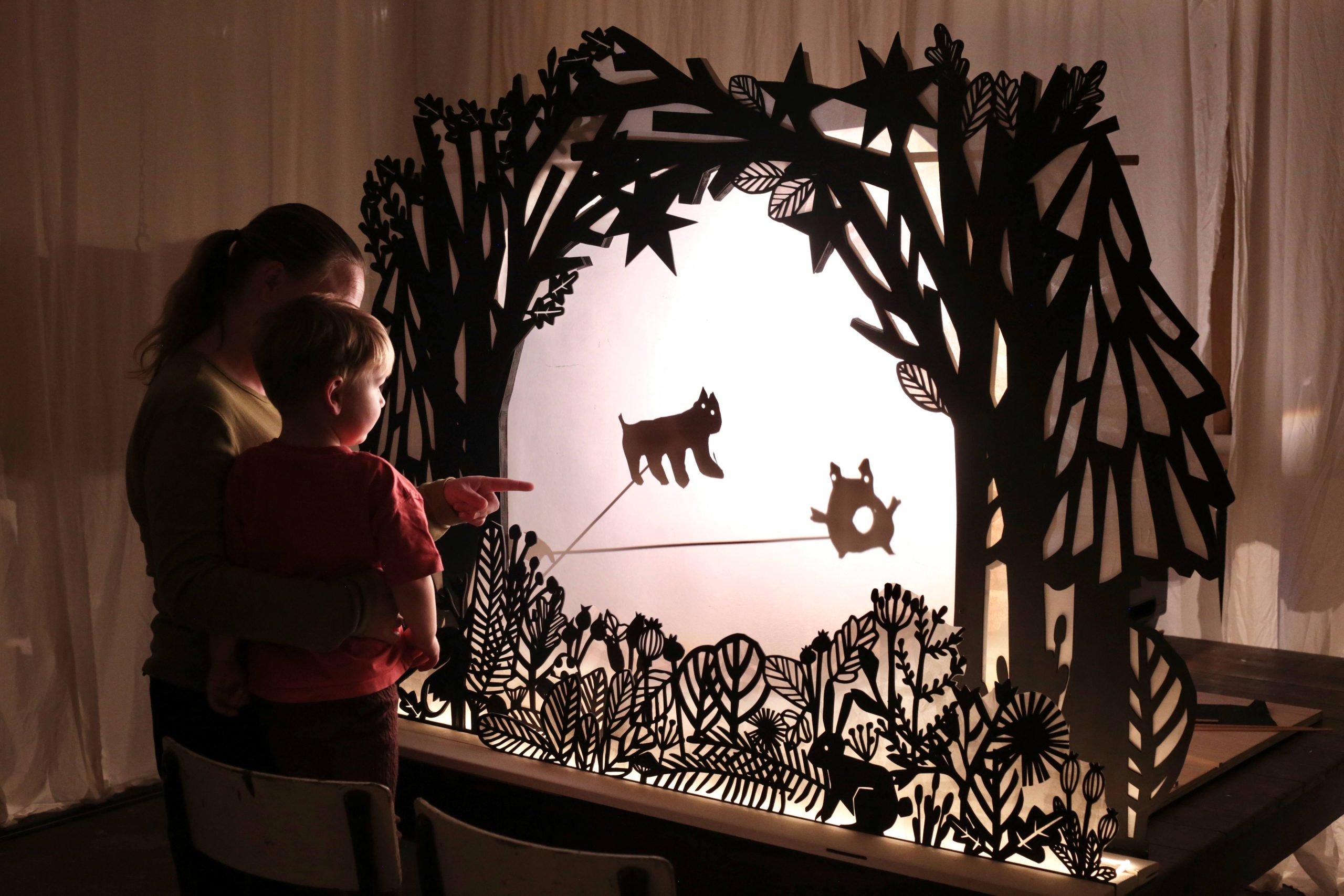 two people playing with shadow puppets