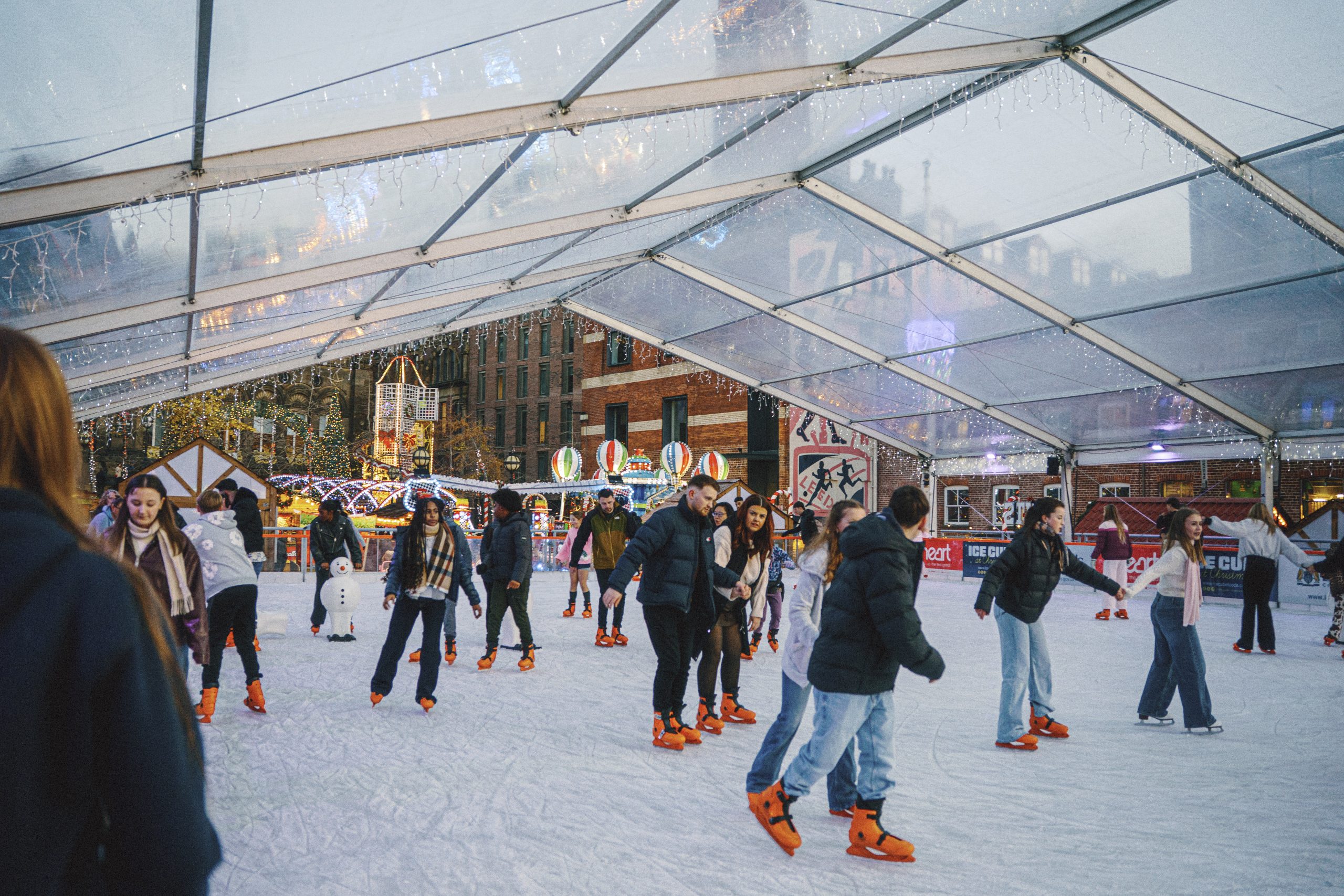 People enjoying undercover outdoor ice skating at Millennium Square Ice Cube